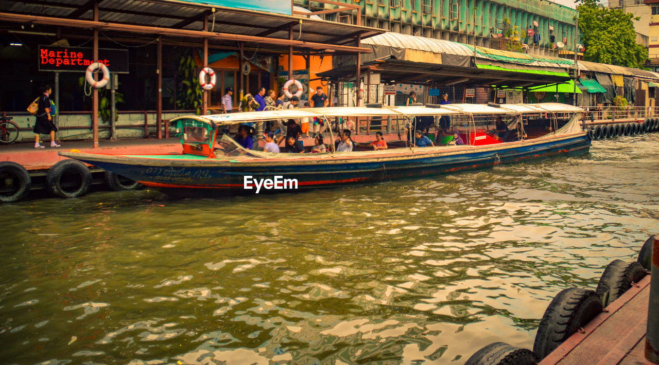 PEOPLE IN BOAT ON SHORE