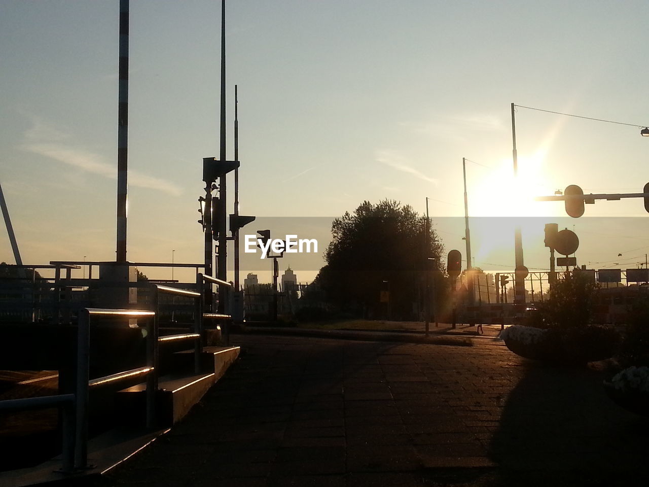 Traffic lights by street during sunset