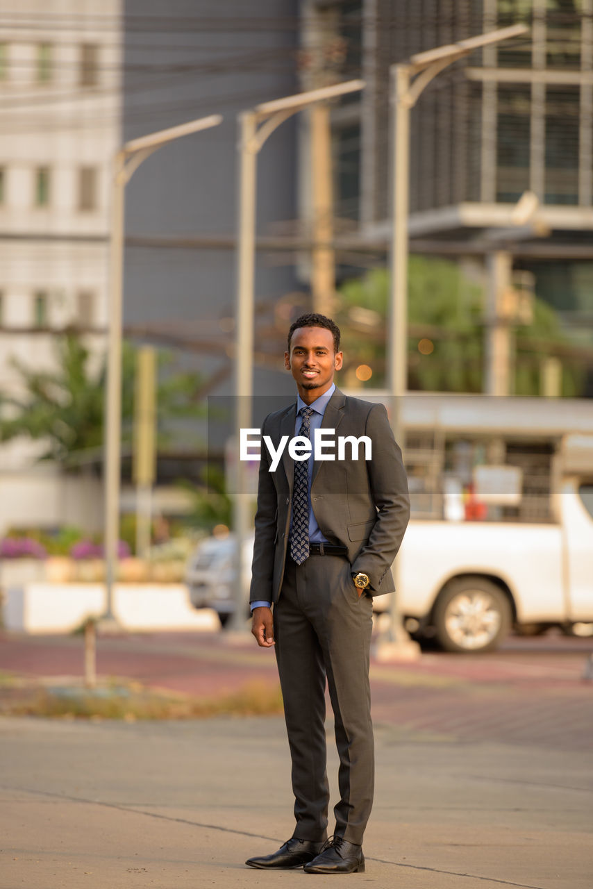 Portrait of businessman standing in city