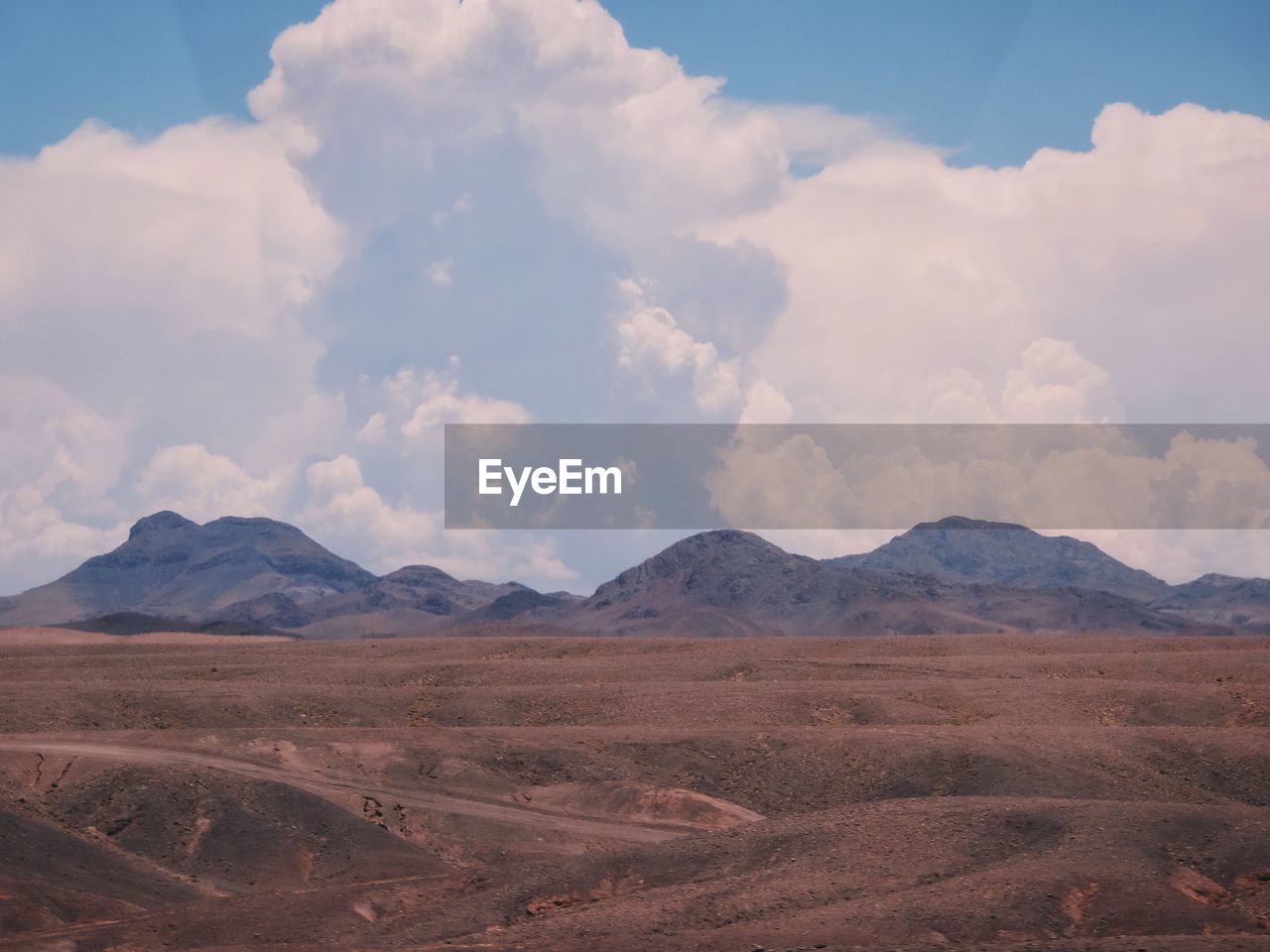 Scenic view of arid landscape against sky