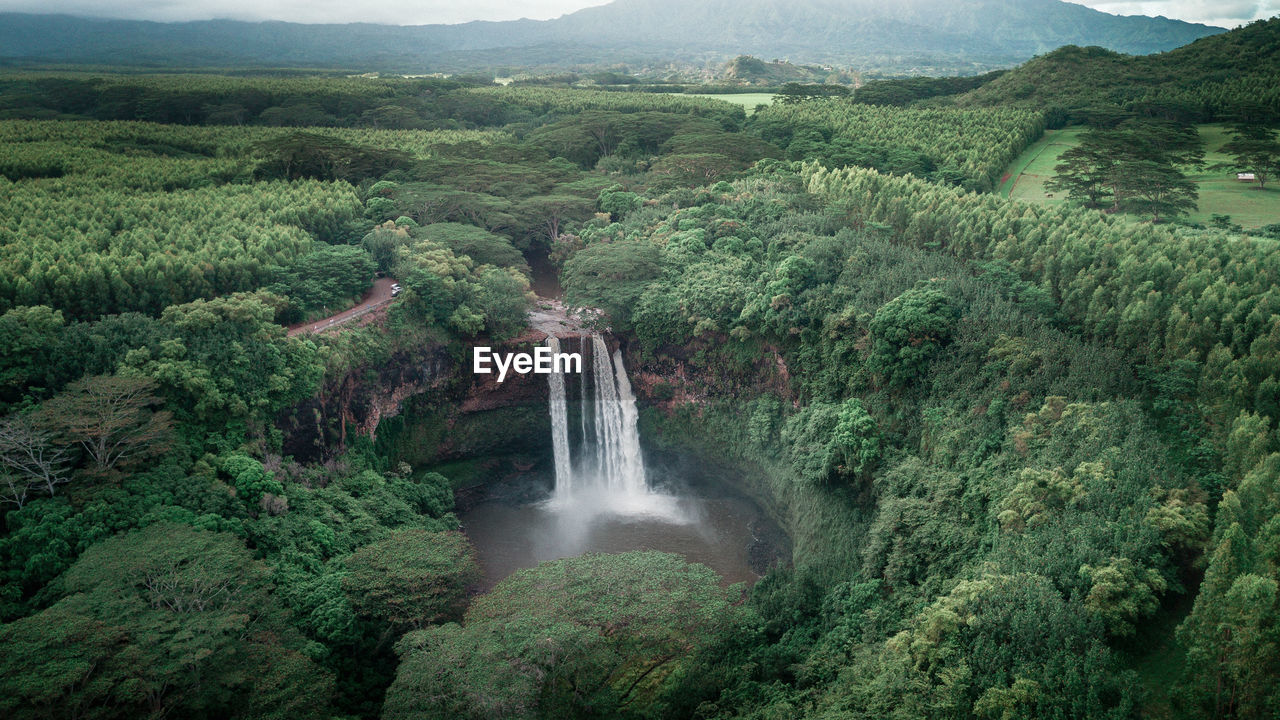Scenic view of waterfall against sky