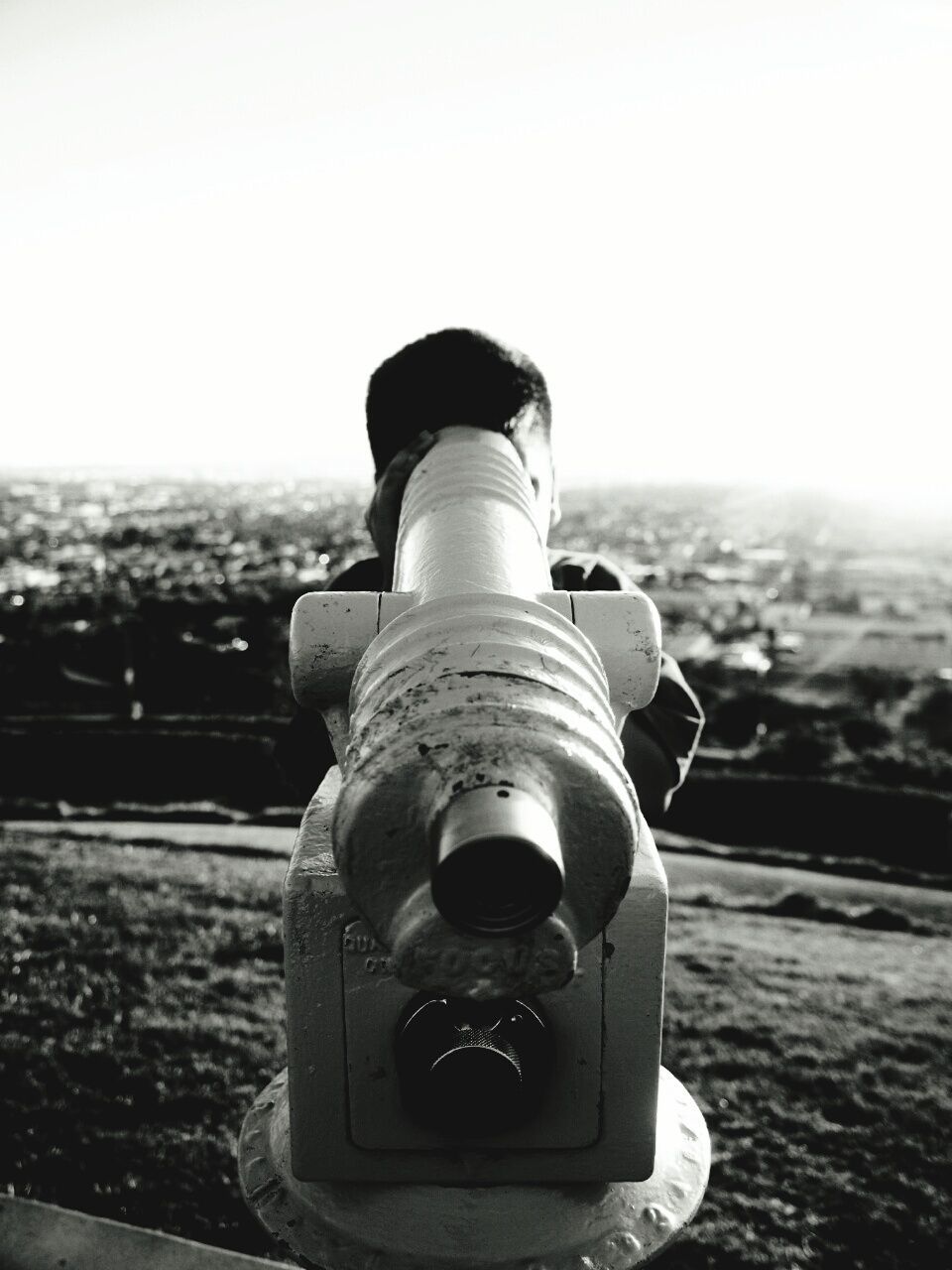 Boy looking through coin-operated binoculars