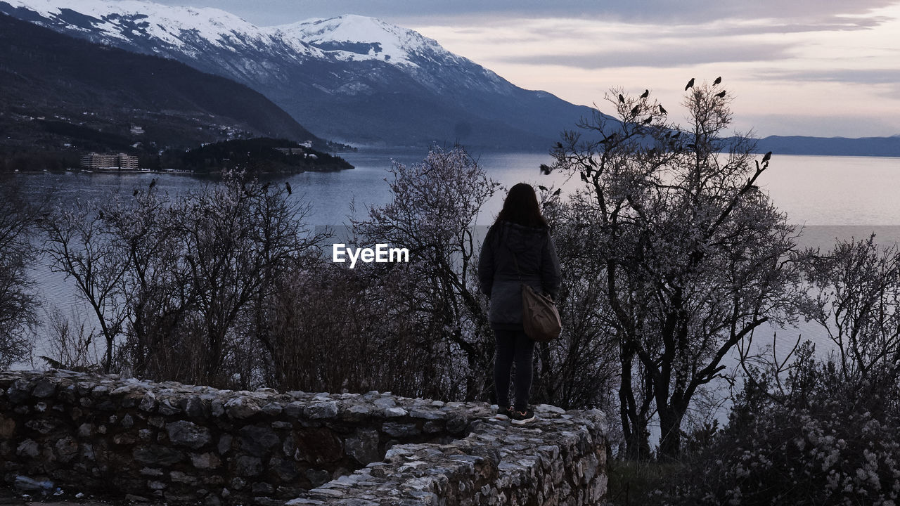 SCENIC VIEW OF LAKE AGAINST SNOW MOUNTAINS