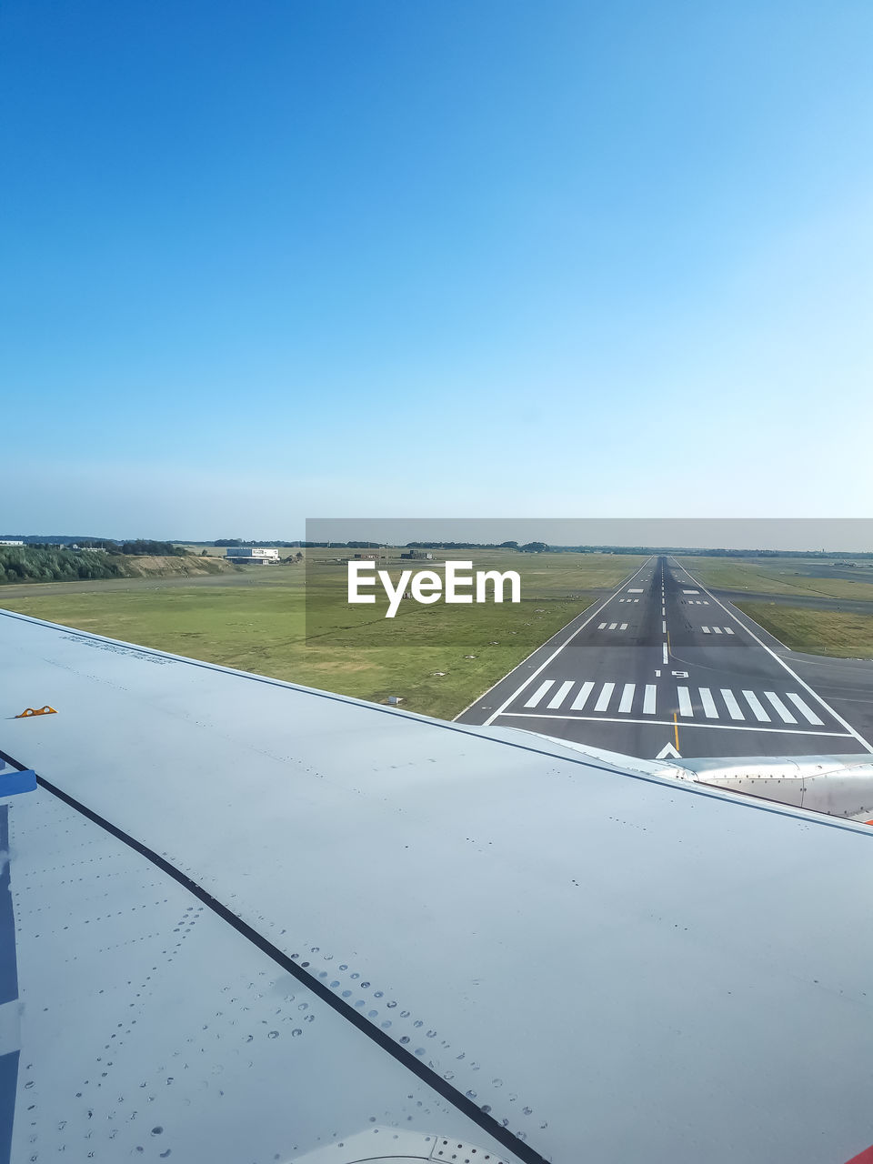 AIRPLANE ON RUNWAY AGAINST CLEAR SKY