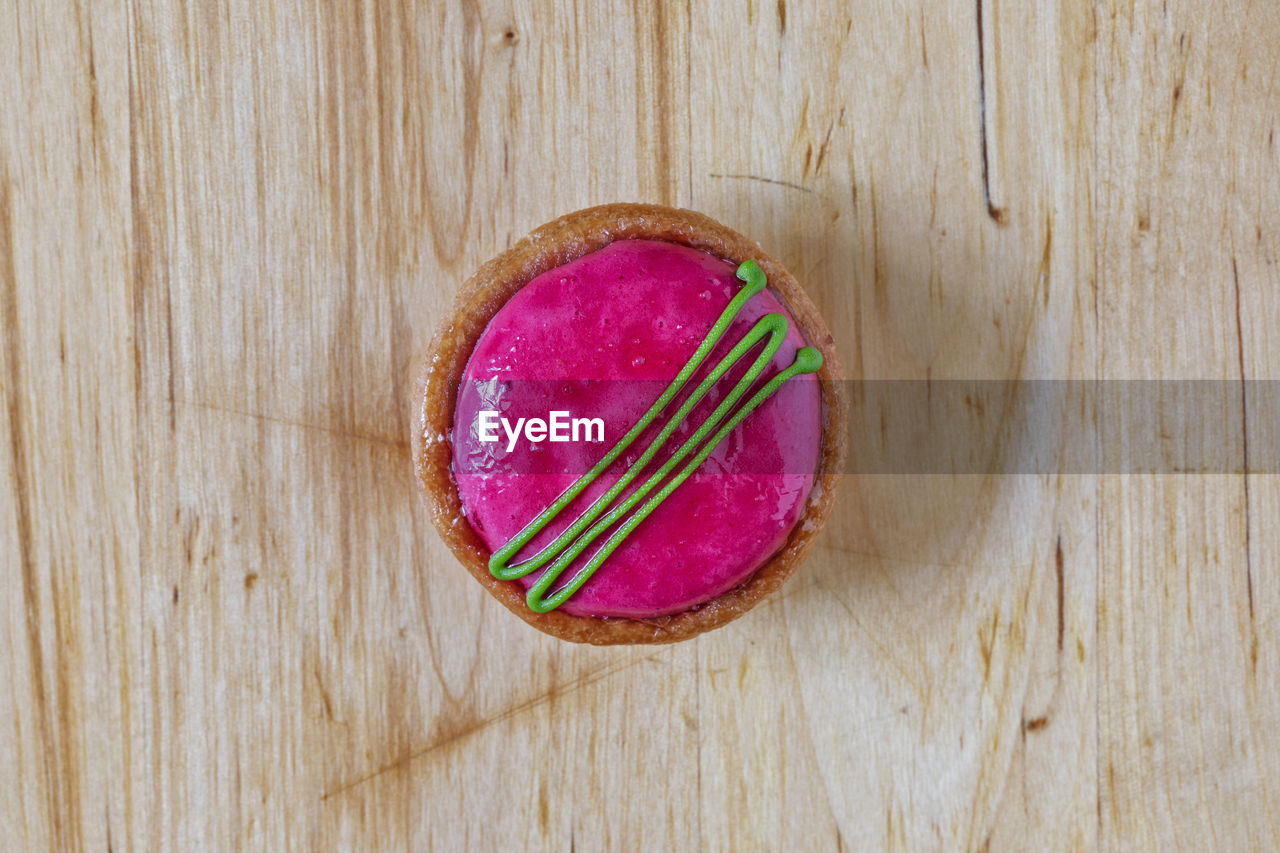 pink, wood, food and drink, food, table, no people, indoors, directly above, still life, freshness, high angle view, healthy eating, fashion accessory, close-up, wellbeing, red, single object, produce, fruit, purple, sweet food