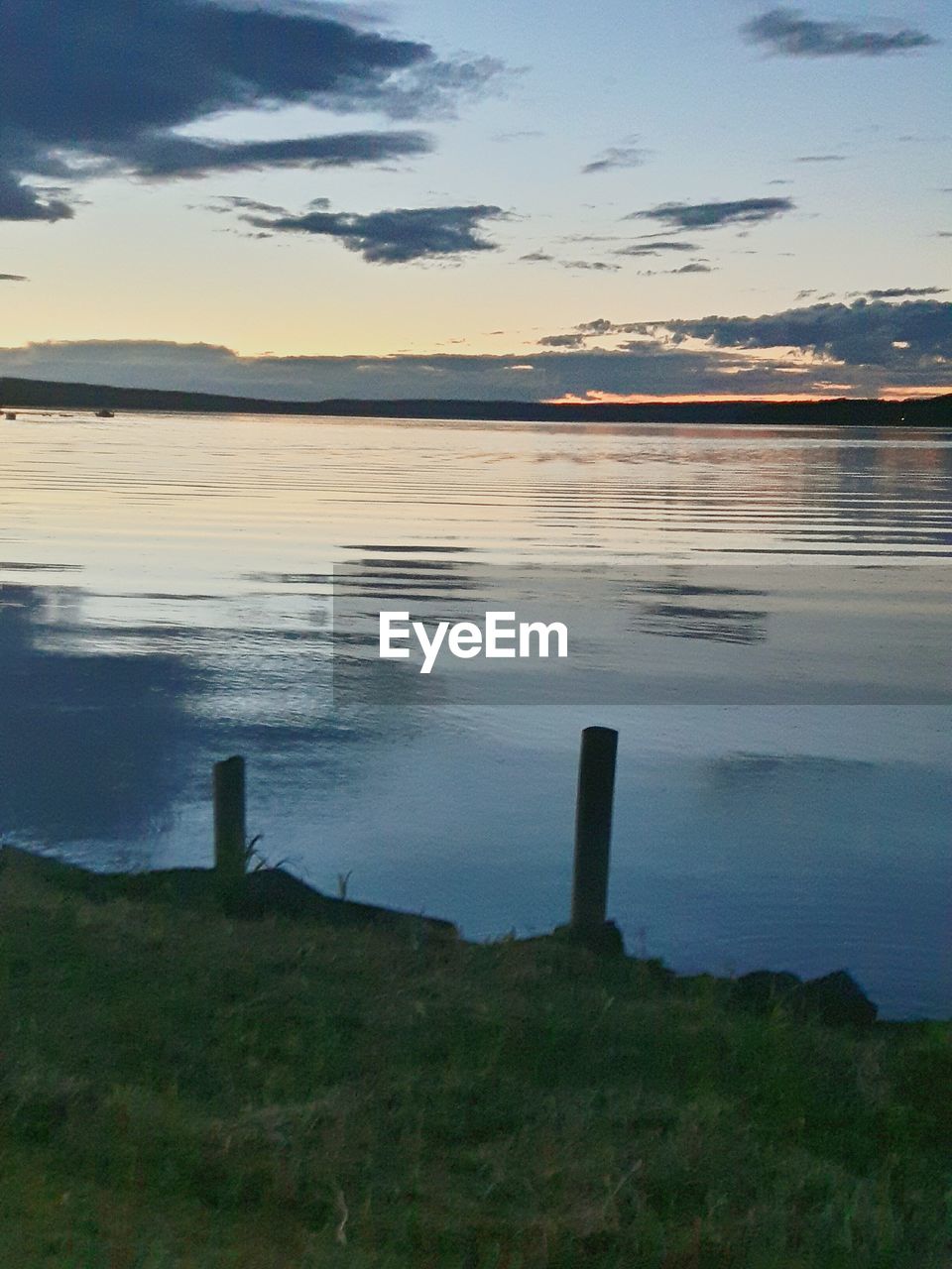 VIEW OF CALM LAKE AGAINST SKY