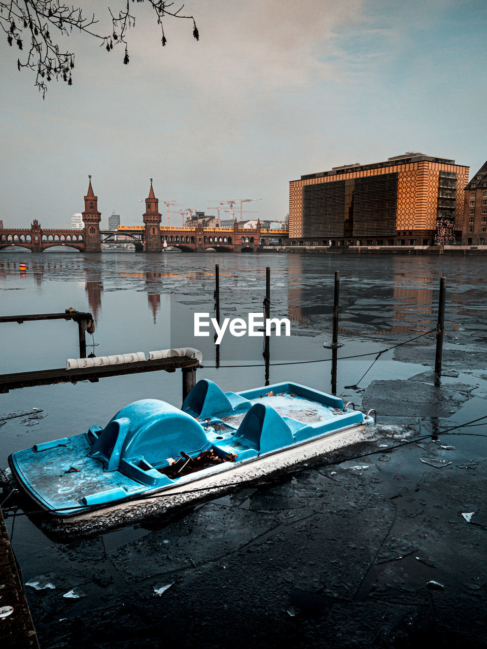 Boats moored in canal against buildings in city