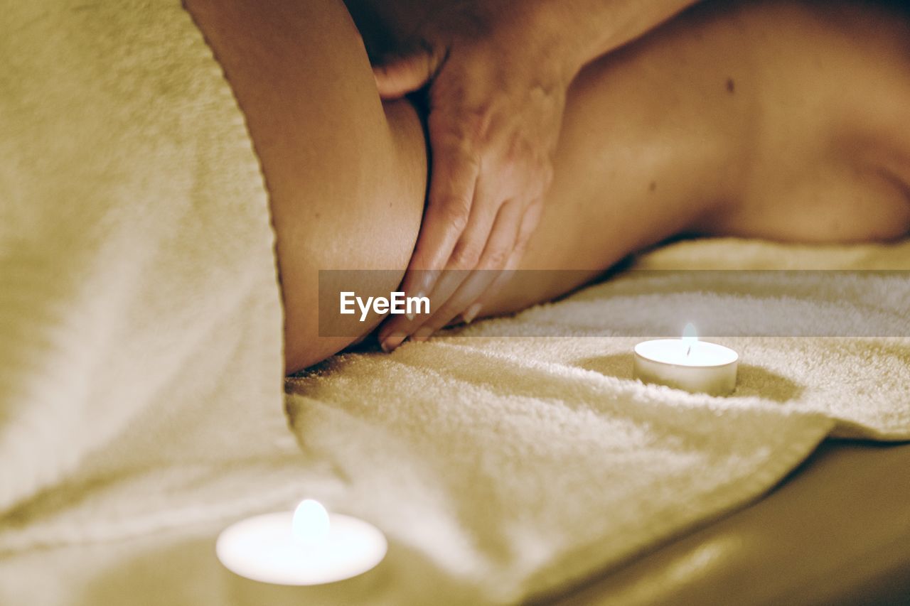 Cropped image of therapist massaging woman at spa