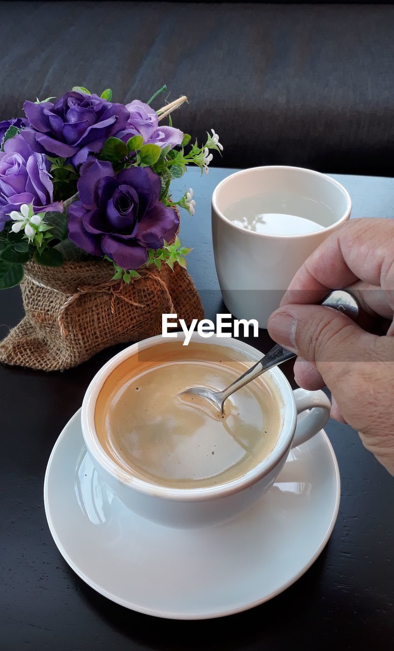 COFFEE CUP ON TABLE AT CAFE