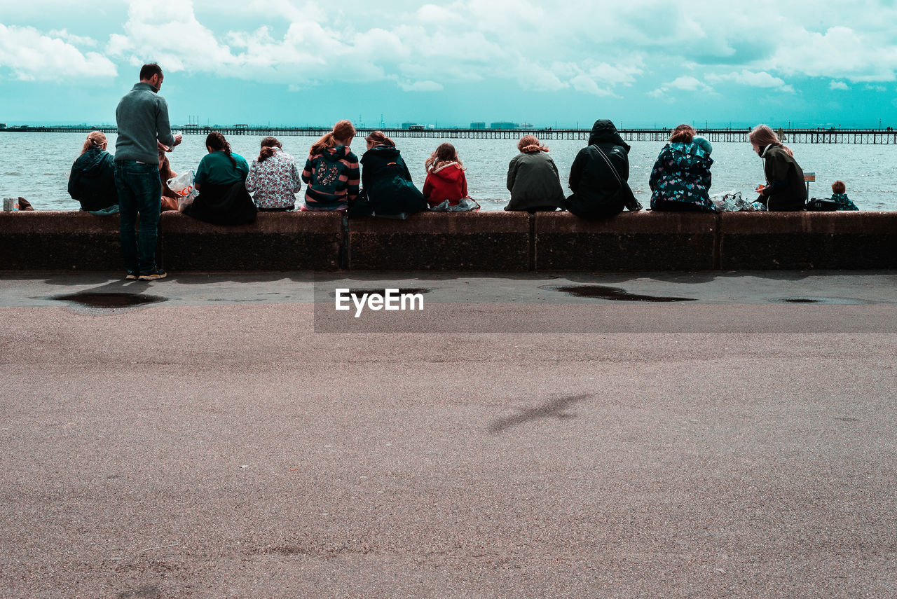 PEOPLE LOOKING AT SEA