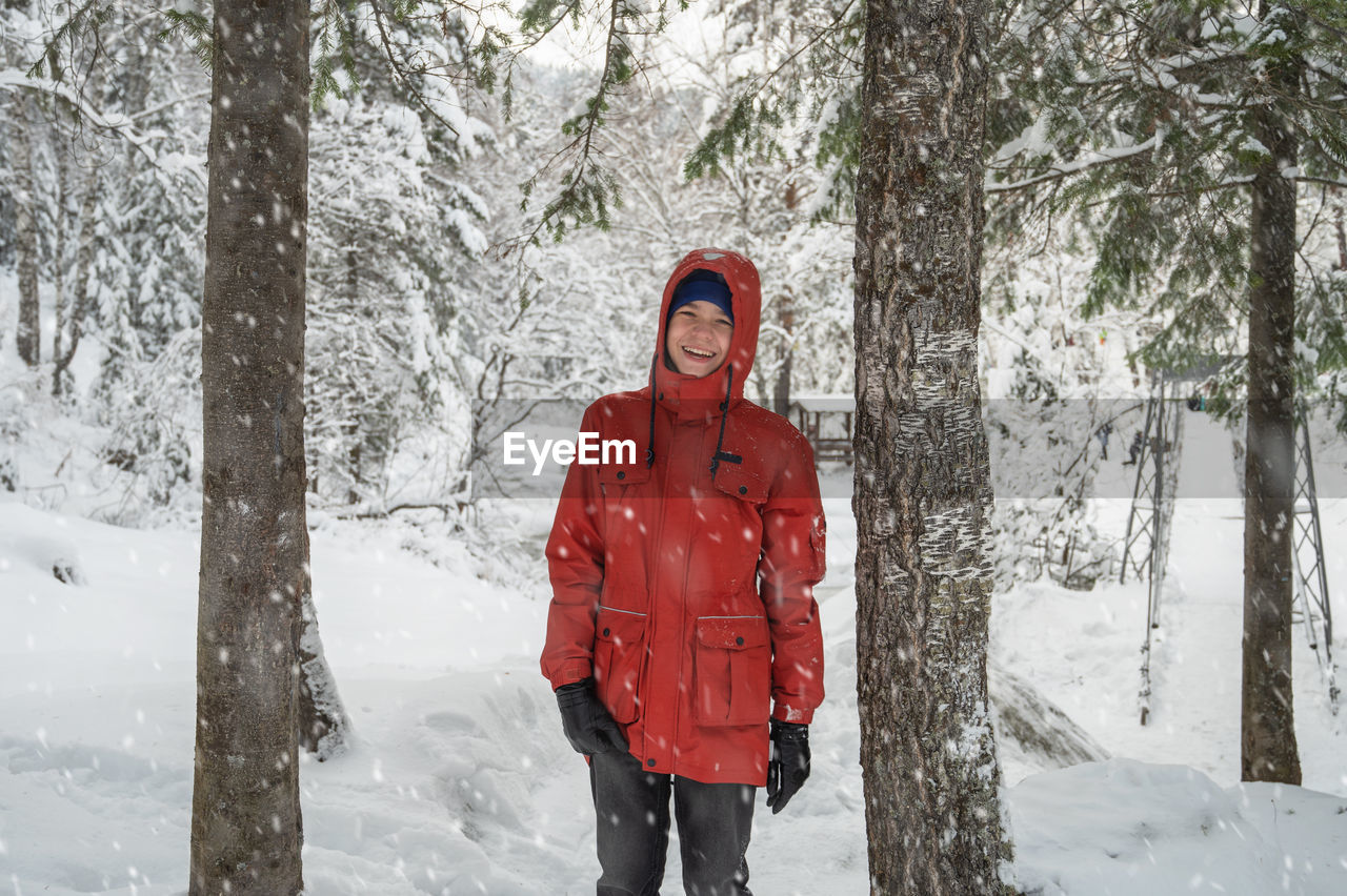 young woman standing in snow