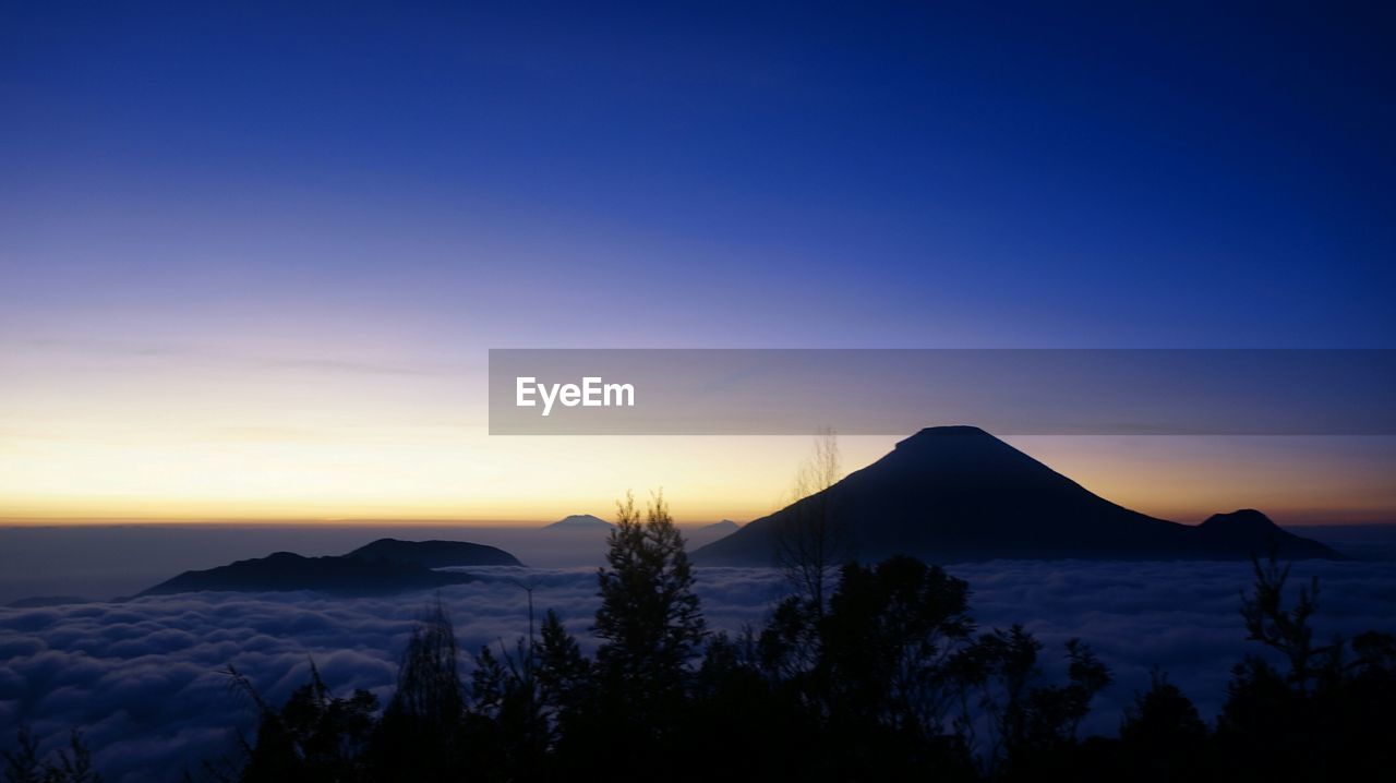 Scenic view of silhouette mountains against sky at sunset