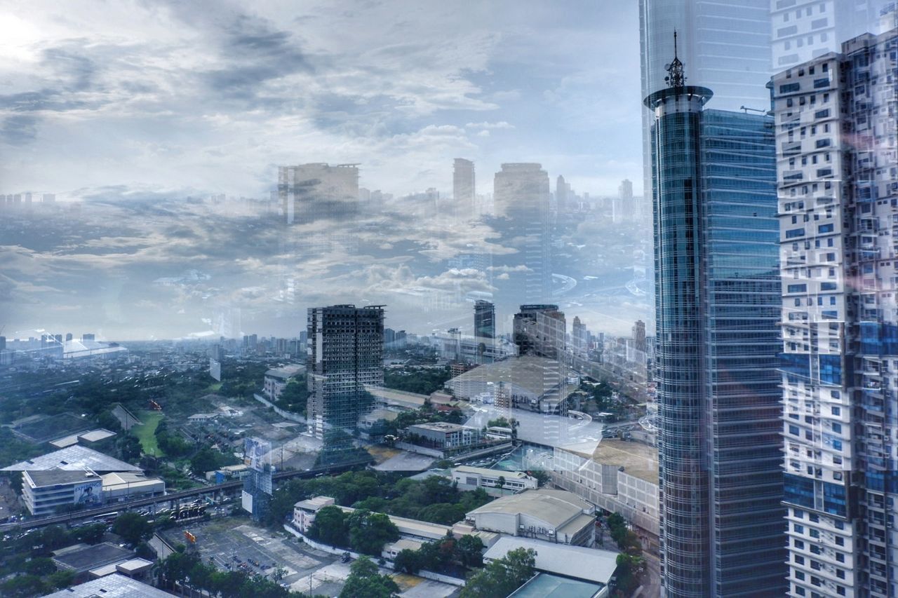 HIGH ANGLE VIEW OF BUILDINGS AGAINST SKY IN CITY