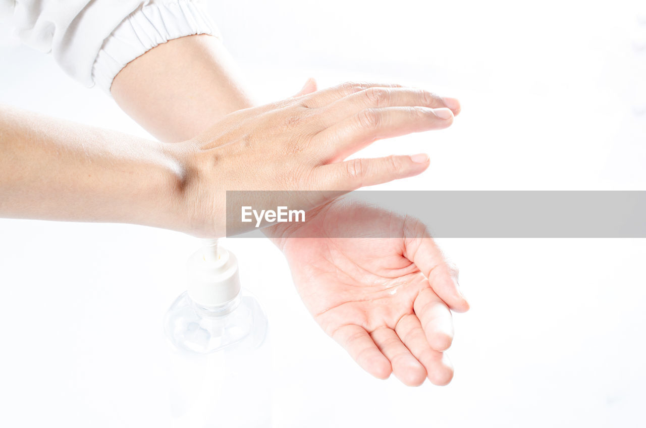 Close-up of woman hand over white background