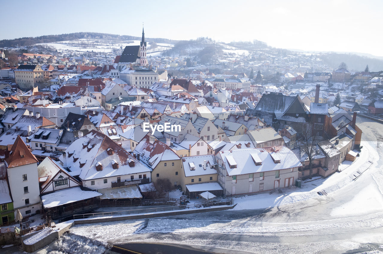 High angle view of houses in town against sky