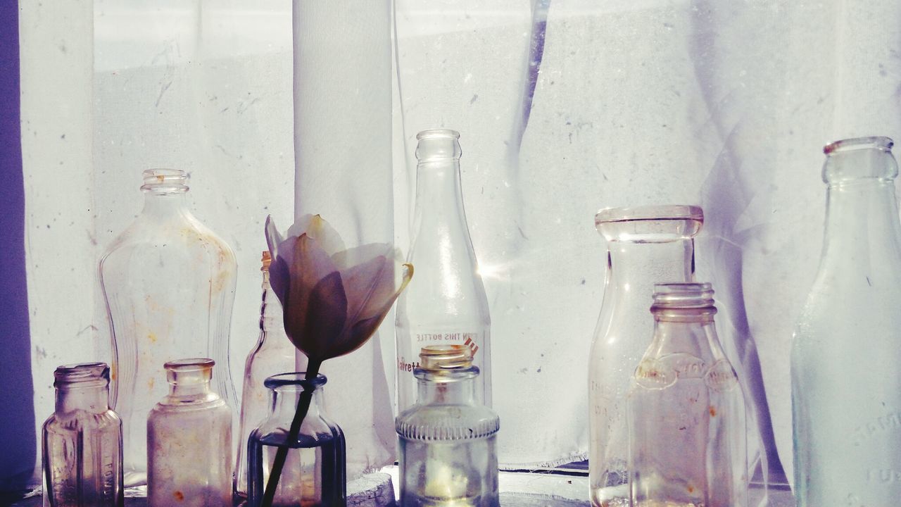 Close-up of bottles against the wall