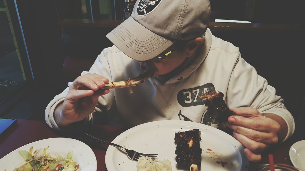 Man eating meat in restaurant