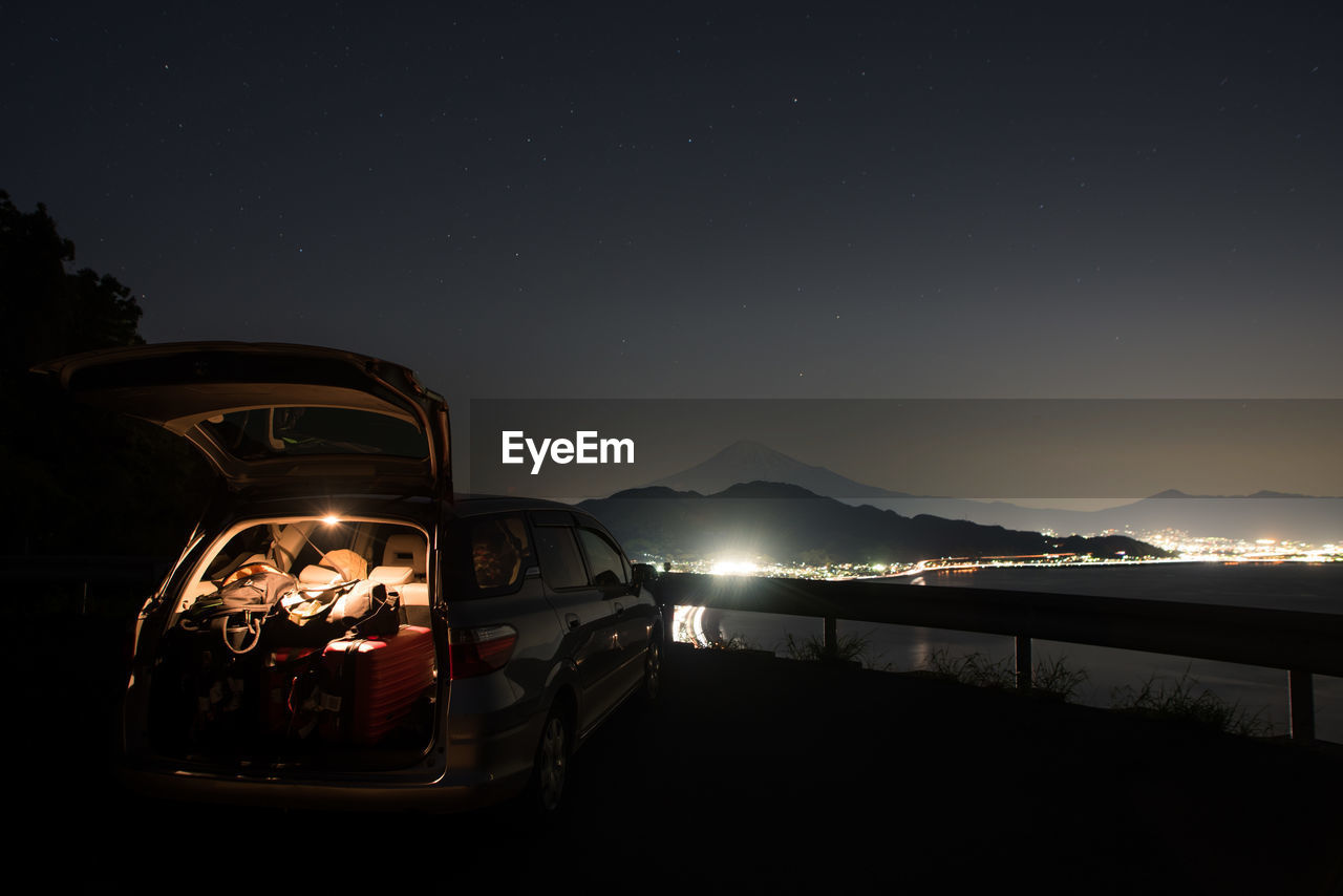 ILLUMINATED CAR ON MOUNTAIN AT NIGHT