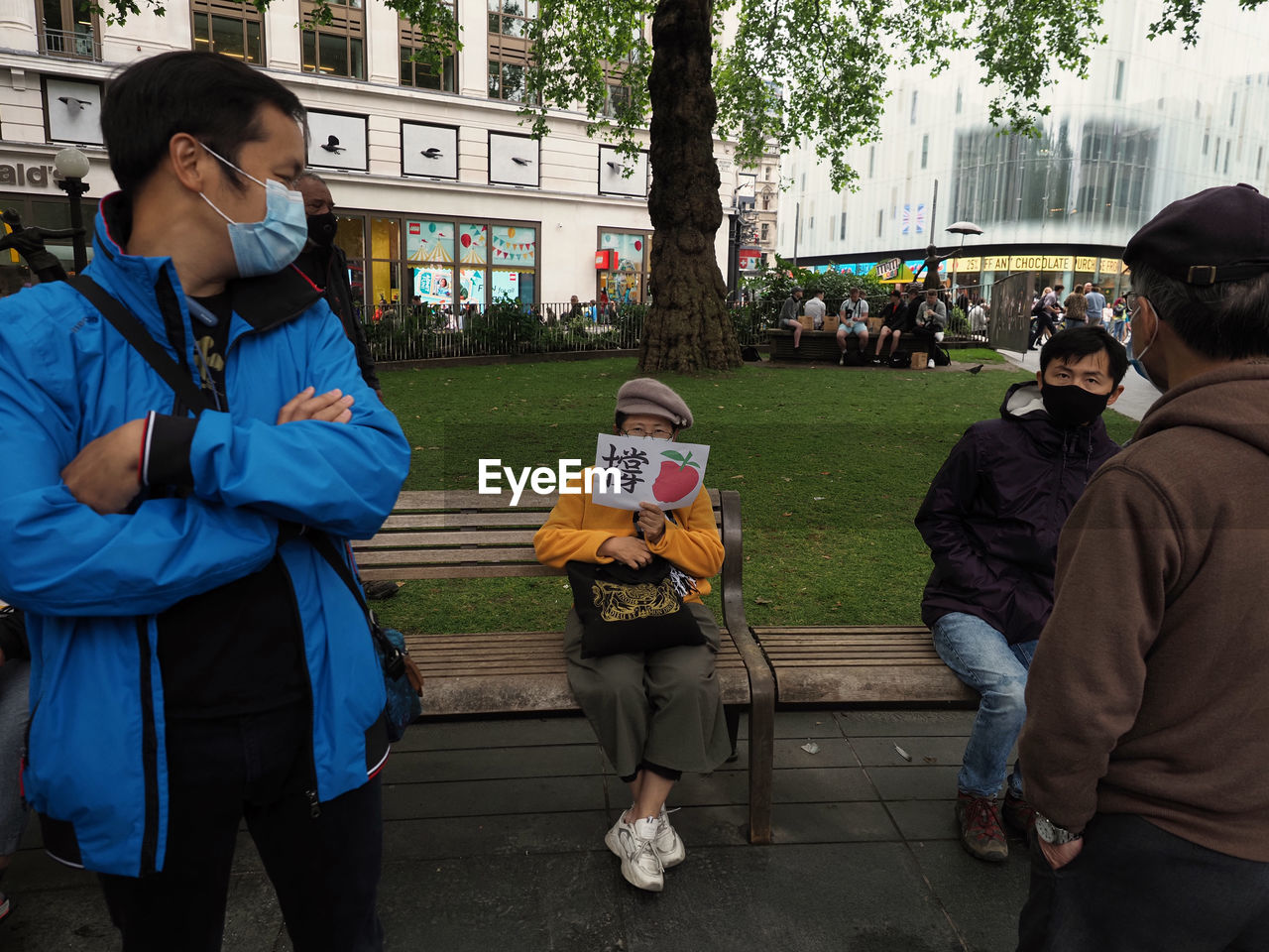 PEOPLE STANDING IN FRONT OF BUILDINGS