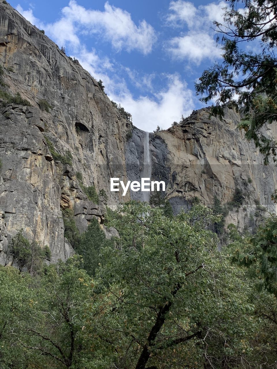 Low angle view of rocky mountains against sky