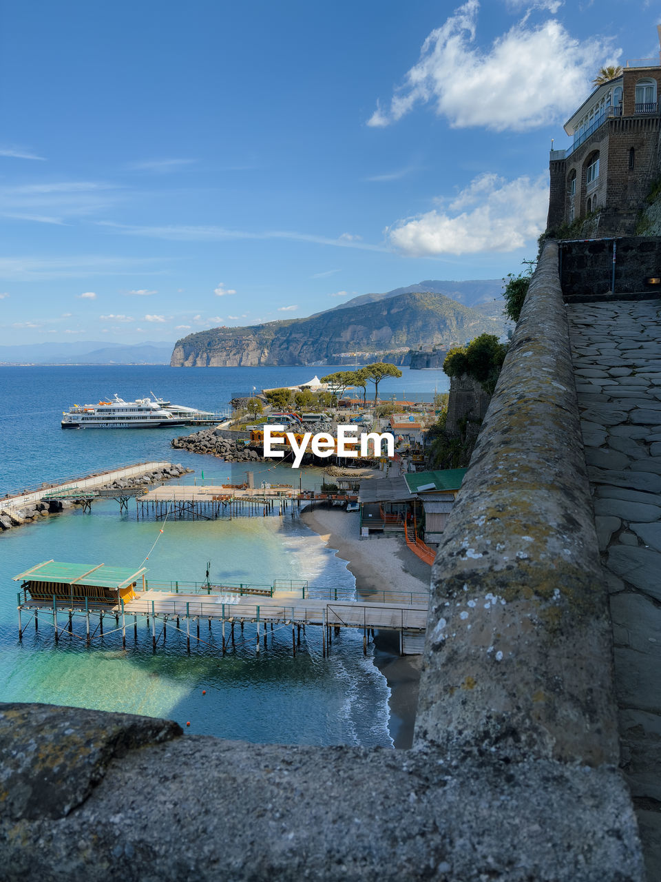 water, sea, coast, architecture, sky, vacation, built structure, nature, building exterior, ocean, cloud, shore, travel destinations, building, land, nautical vessel, travel, beach, bay, blue, transportation, day, no people, reflection, outdoors, scenics - nature, beauty in nature, city, tourism, harbor, body of water, house, holiday