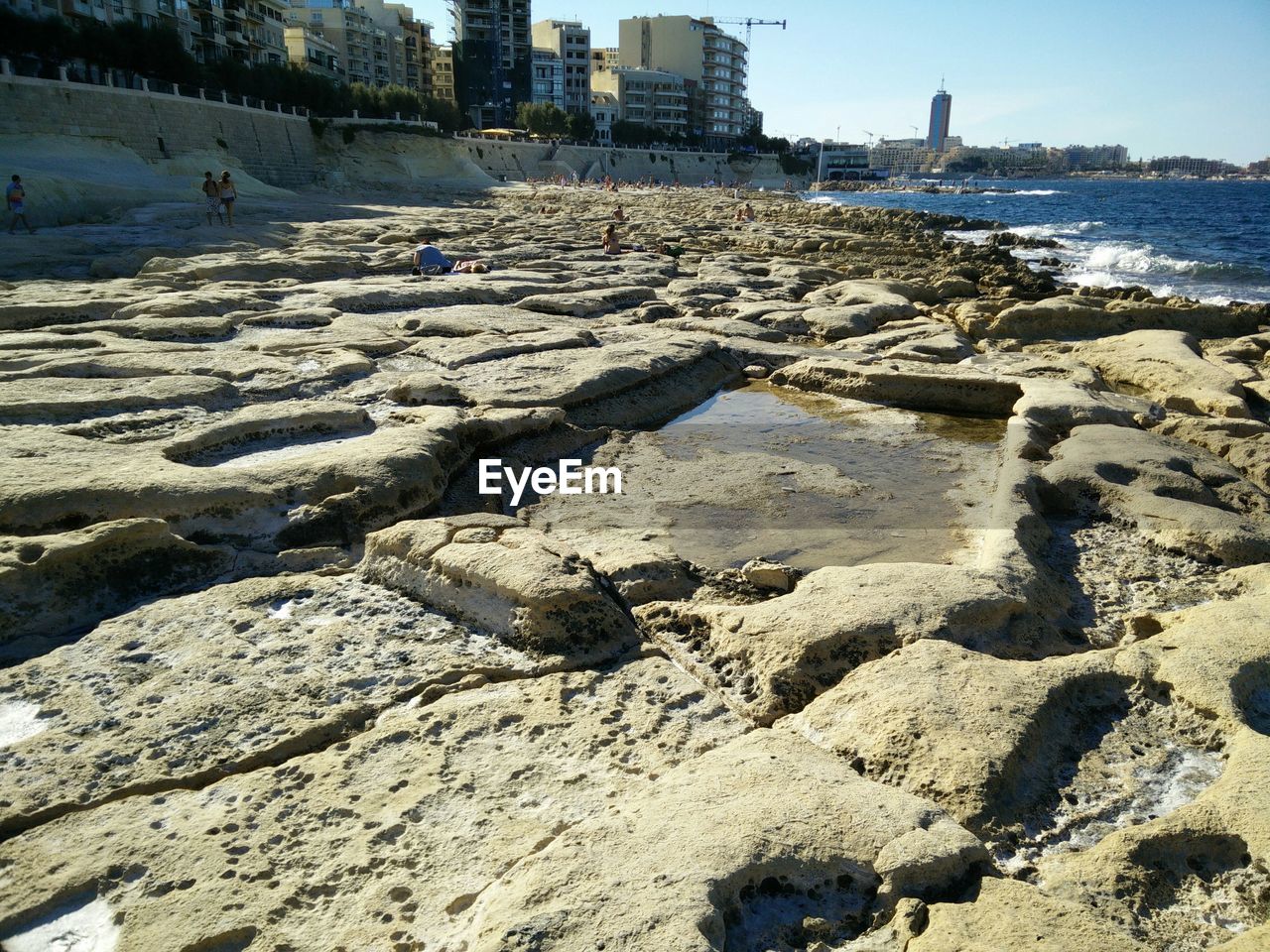 VIEW OF BUILT STRUCTURE WITH SEA IN BACKGROUND