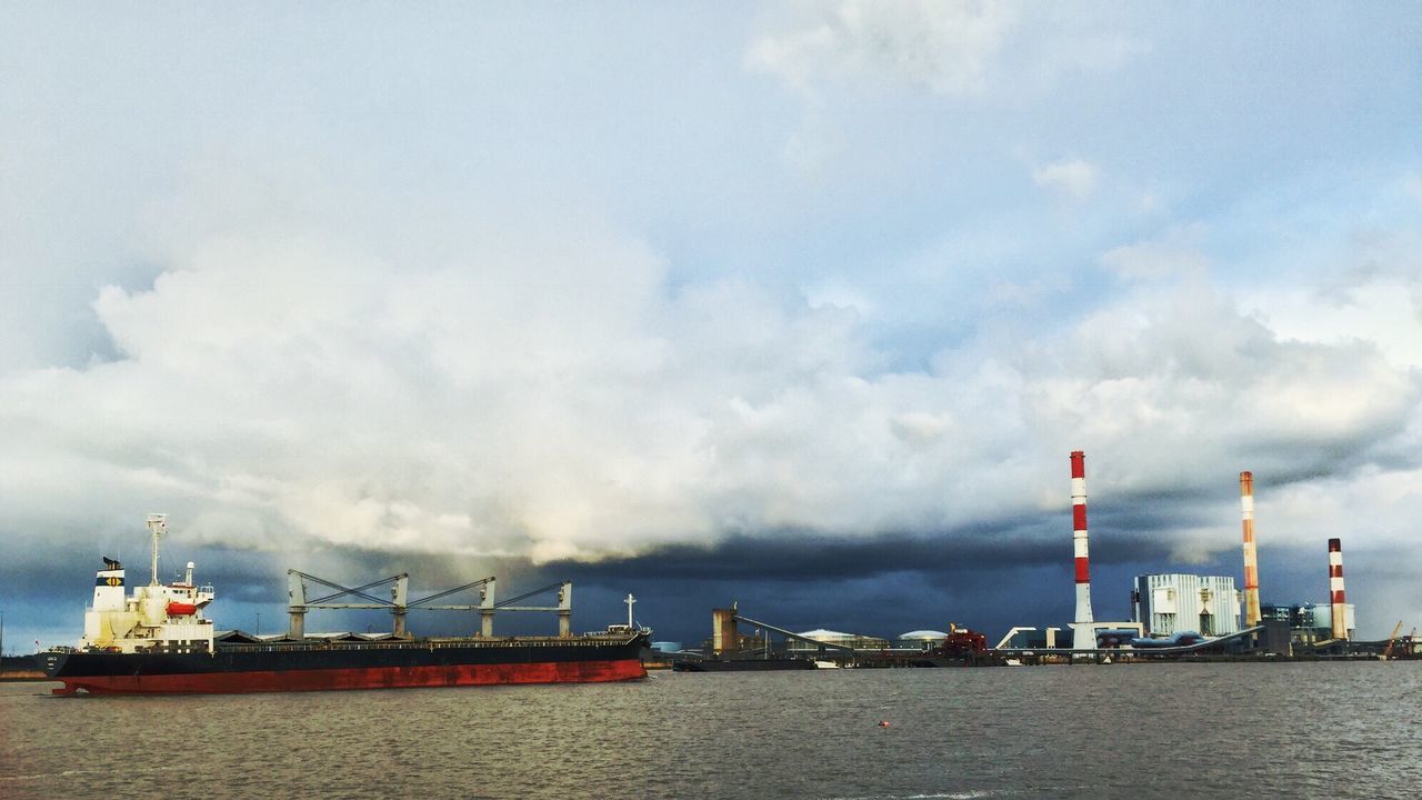 VIEW OF HARBOR AGAINST CLOUDY SKY