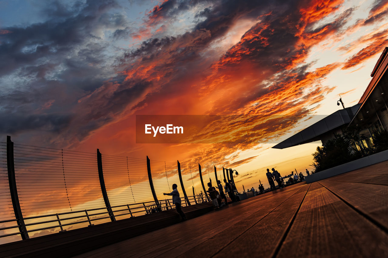 sunset, sky, evening, cloud, dusk, sunlight, horizon, nature, afterglow, architecture, dramatic sky, transportation, silhouette, beauty in nature, orange color, reflection, sun, outdoors, built structure, scenics - nature, travel destinations, city, travel, no people, road, landscape, tranquility, street, water