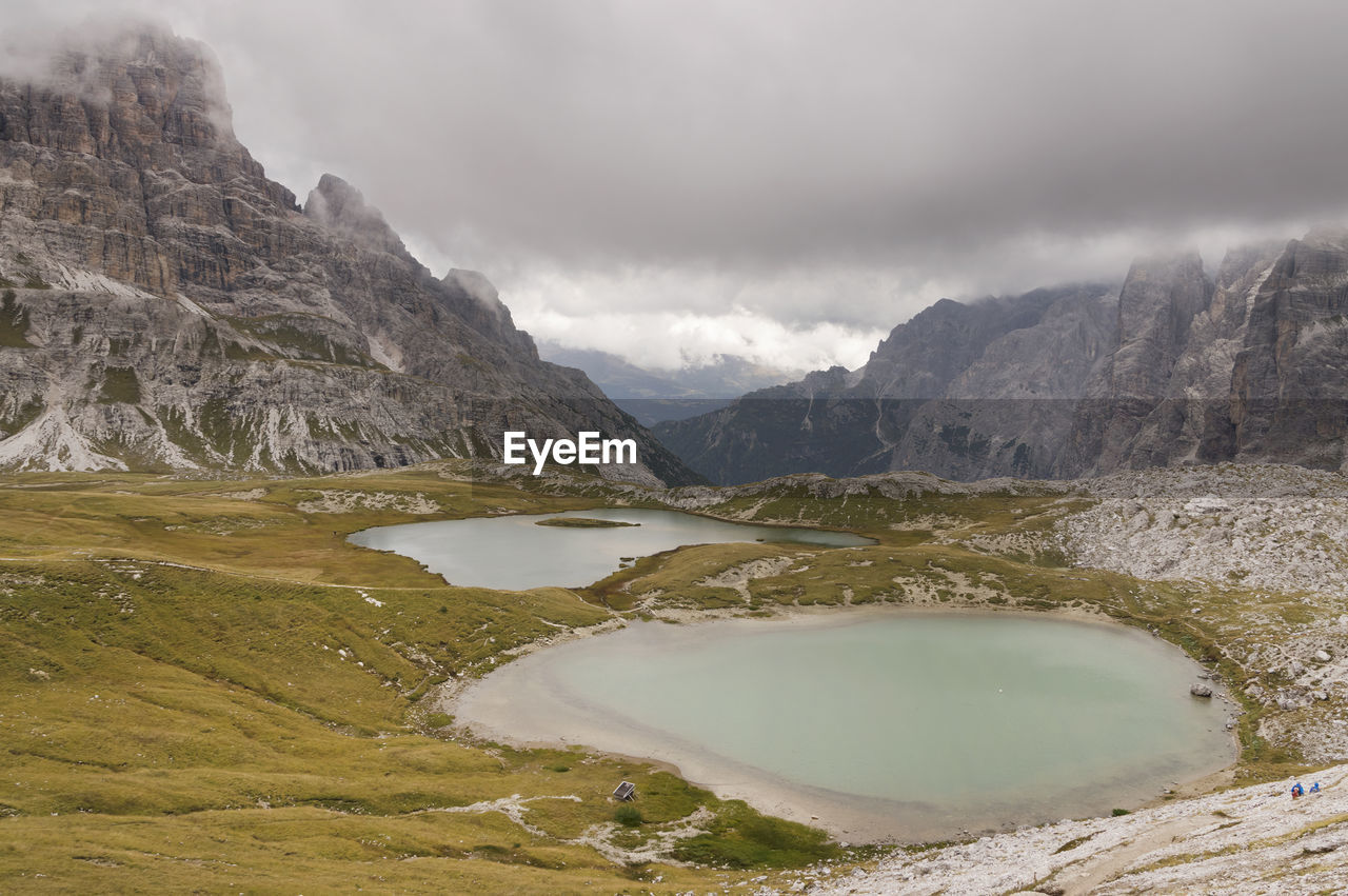 Calm lake against rocky landscape