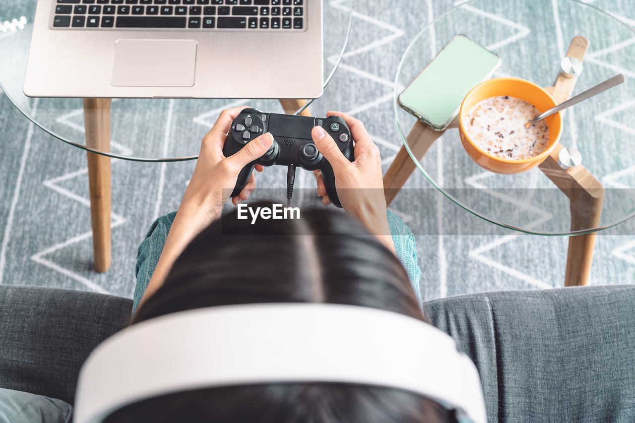 High angle view of woman playing video game