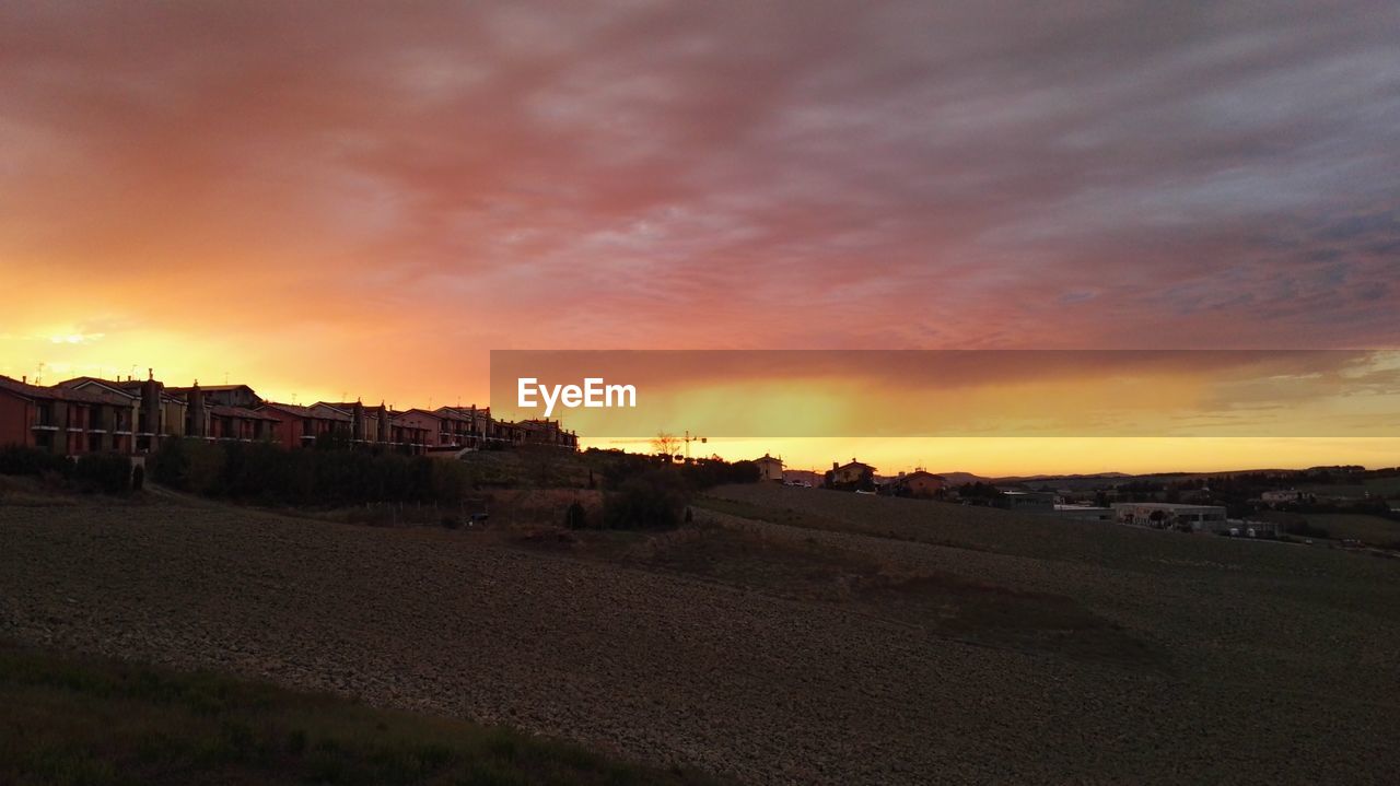 BUILDINGS AGAINST SKY AT SUNSET