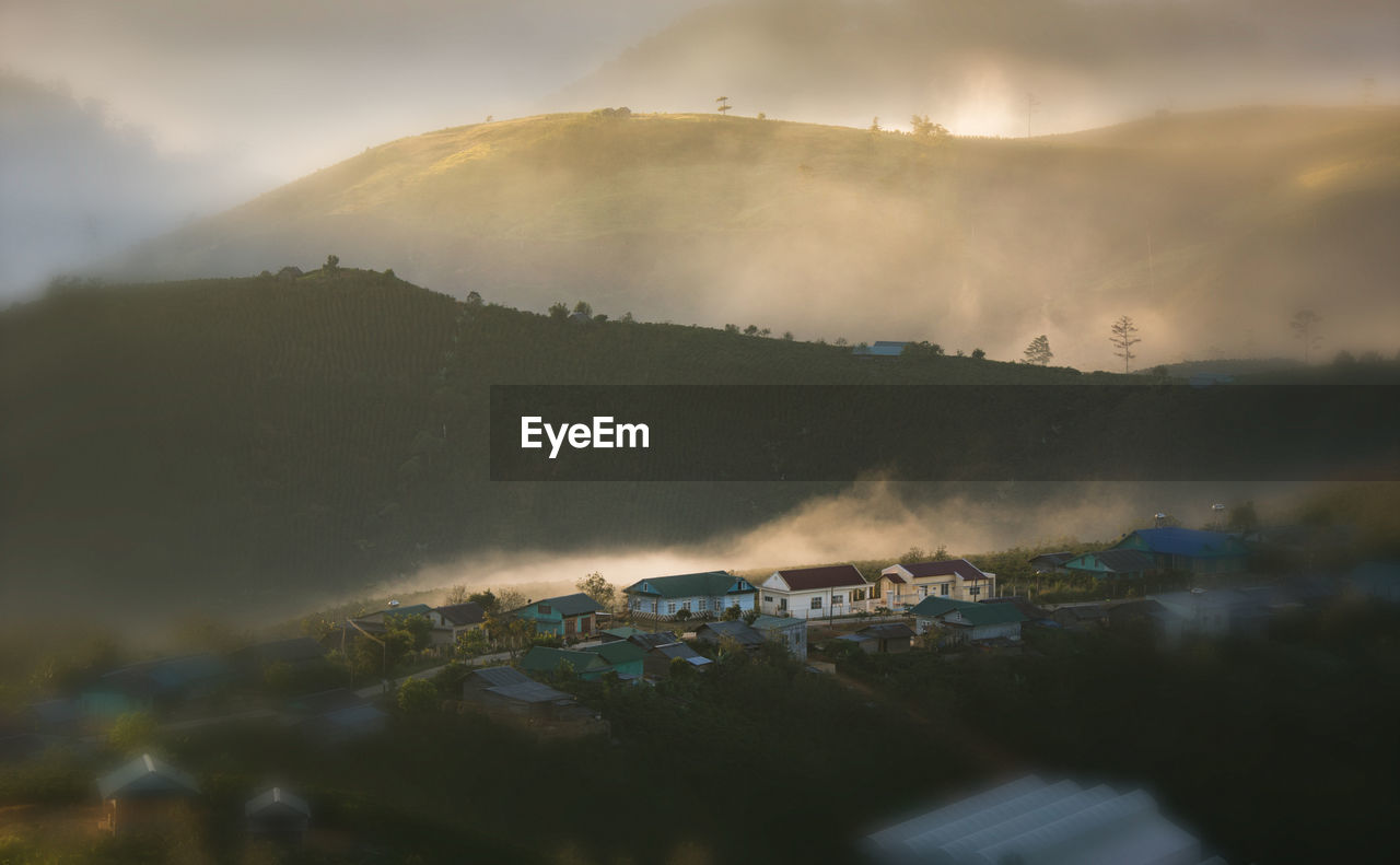 High angle view of houses against mountains during sunset