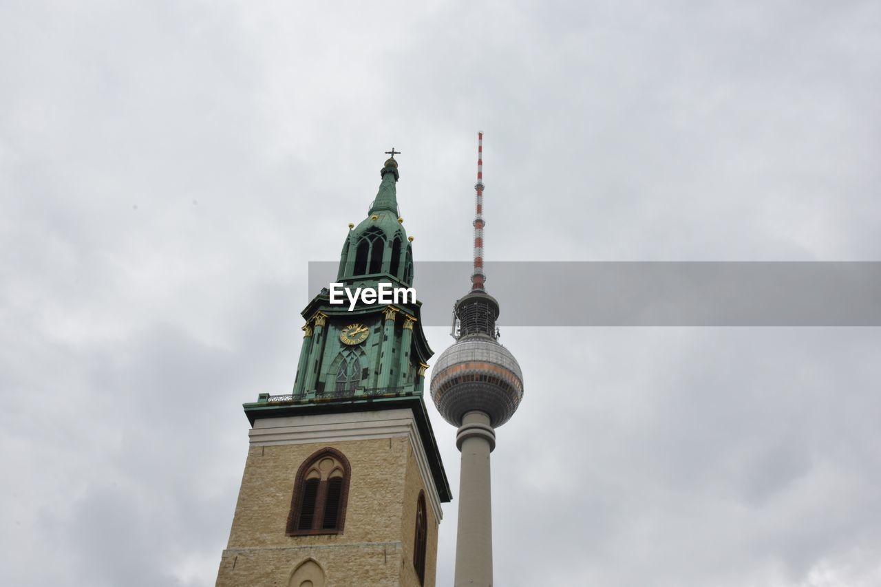 Low angle view of cathedral and fernsehturm against sky