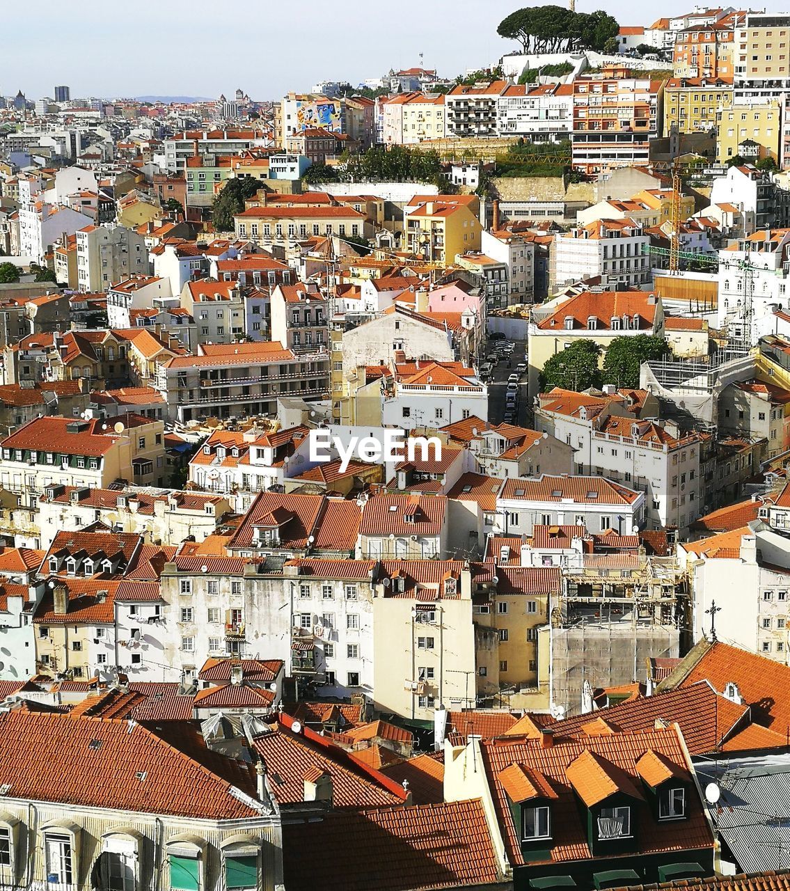 High angle view of houses in town against sky