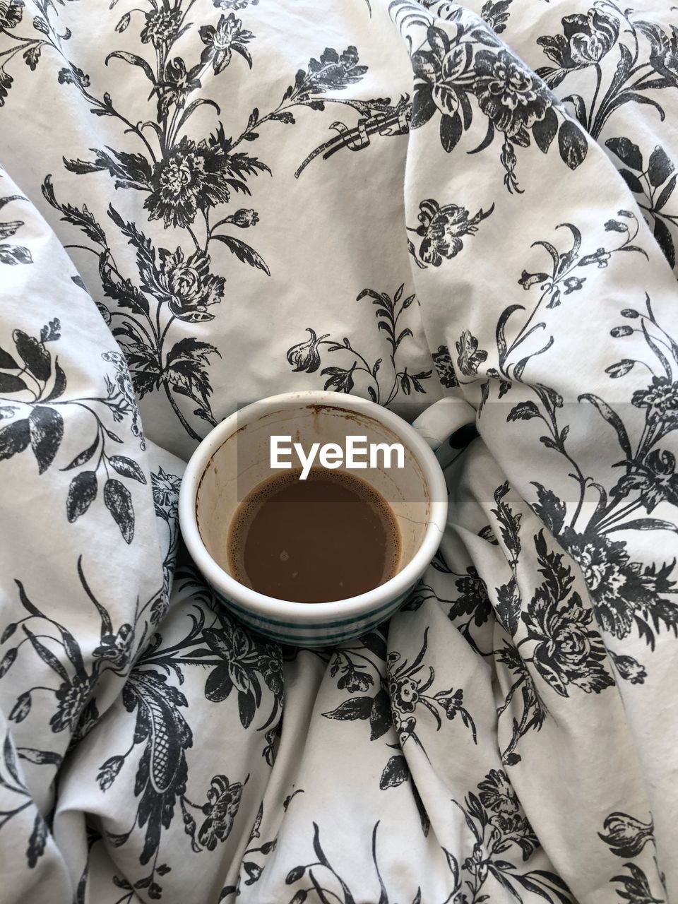 High angle view of coffee on bedsheet