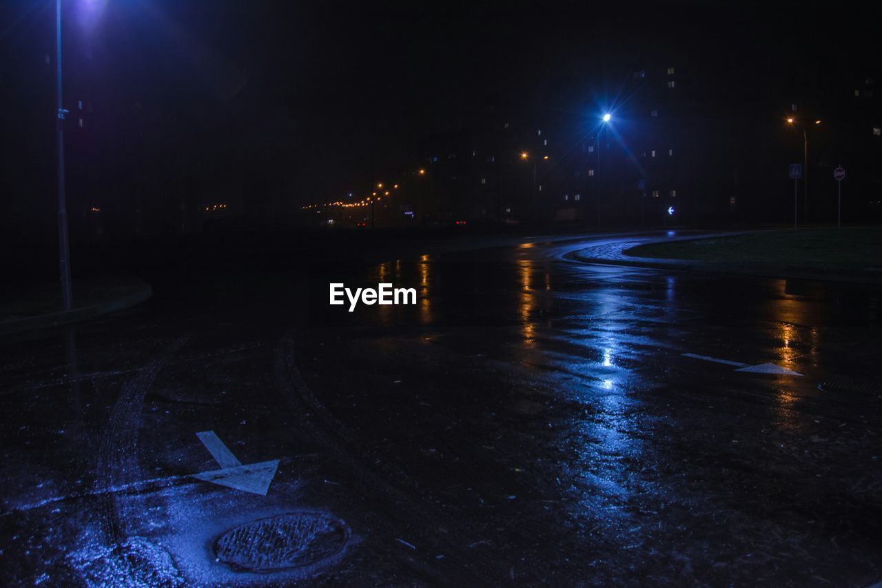 PUDDLE ON ROAD AT NIGHT