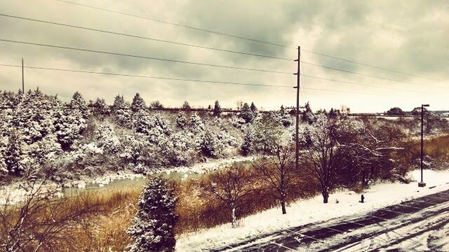 POWER LINES ON SNOW COVERED LANDSCAPE