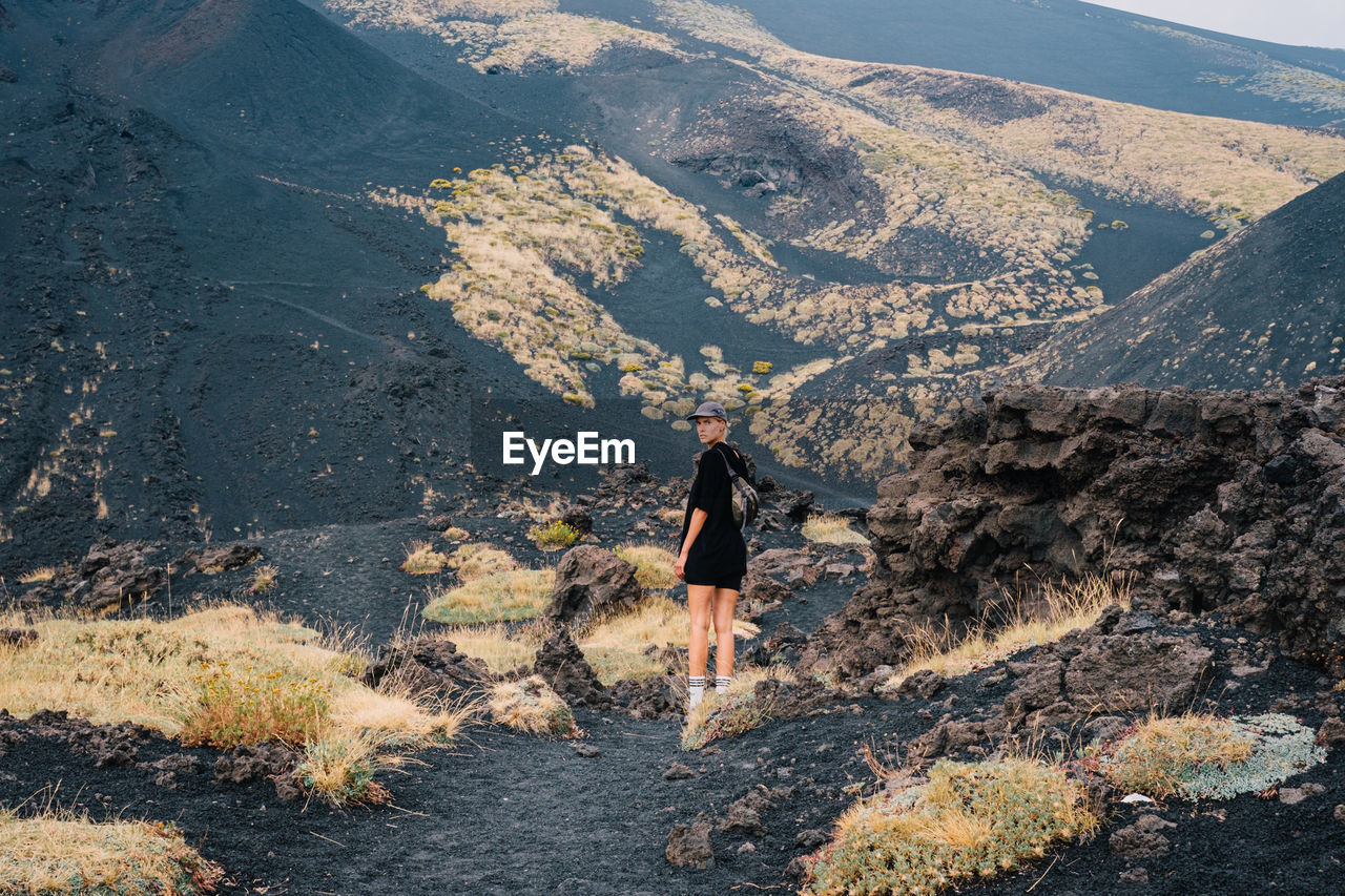 rear view of man standing on mountain