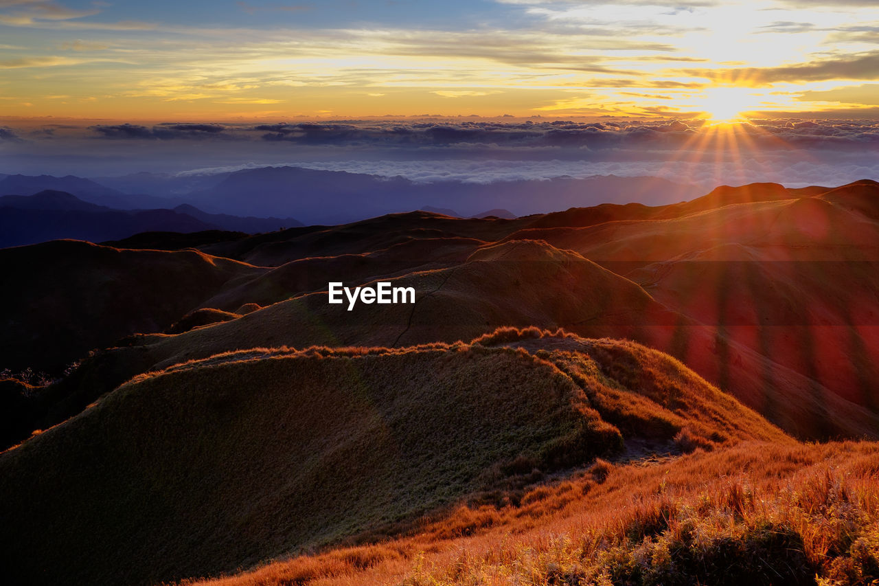 AERIAL VIEW OF LANDSCAPE AGAINST SKY AT SUNSET