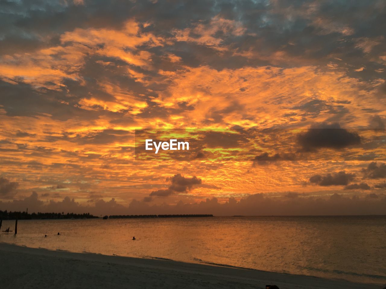 Scenic view of sea against orange sky