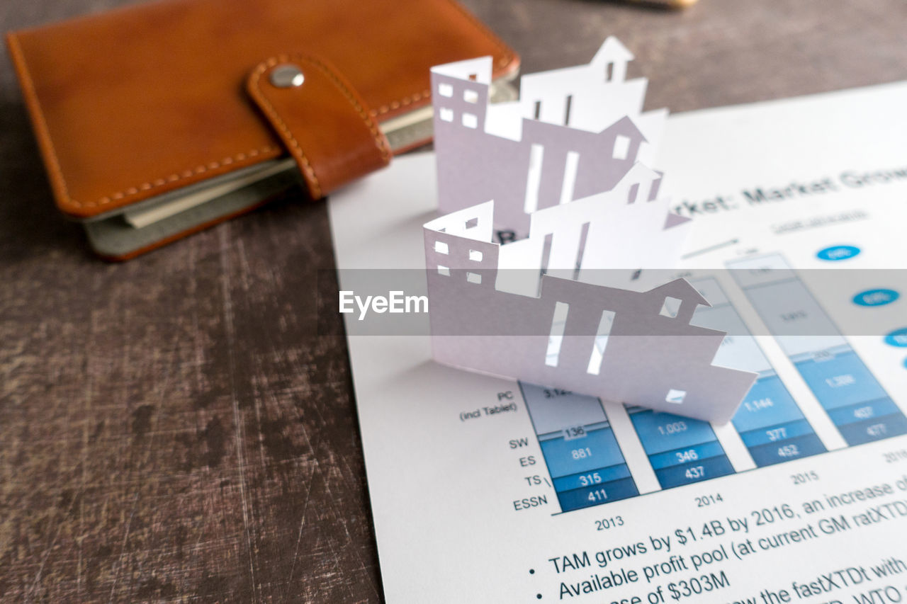 High angle view of paper house with document on table