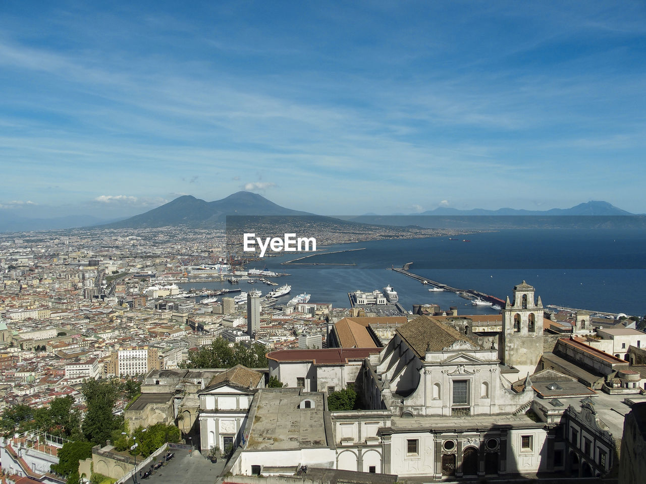 High angle view of townscape by sea against sky