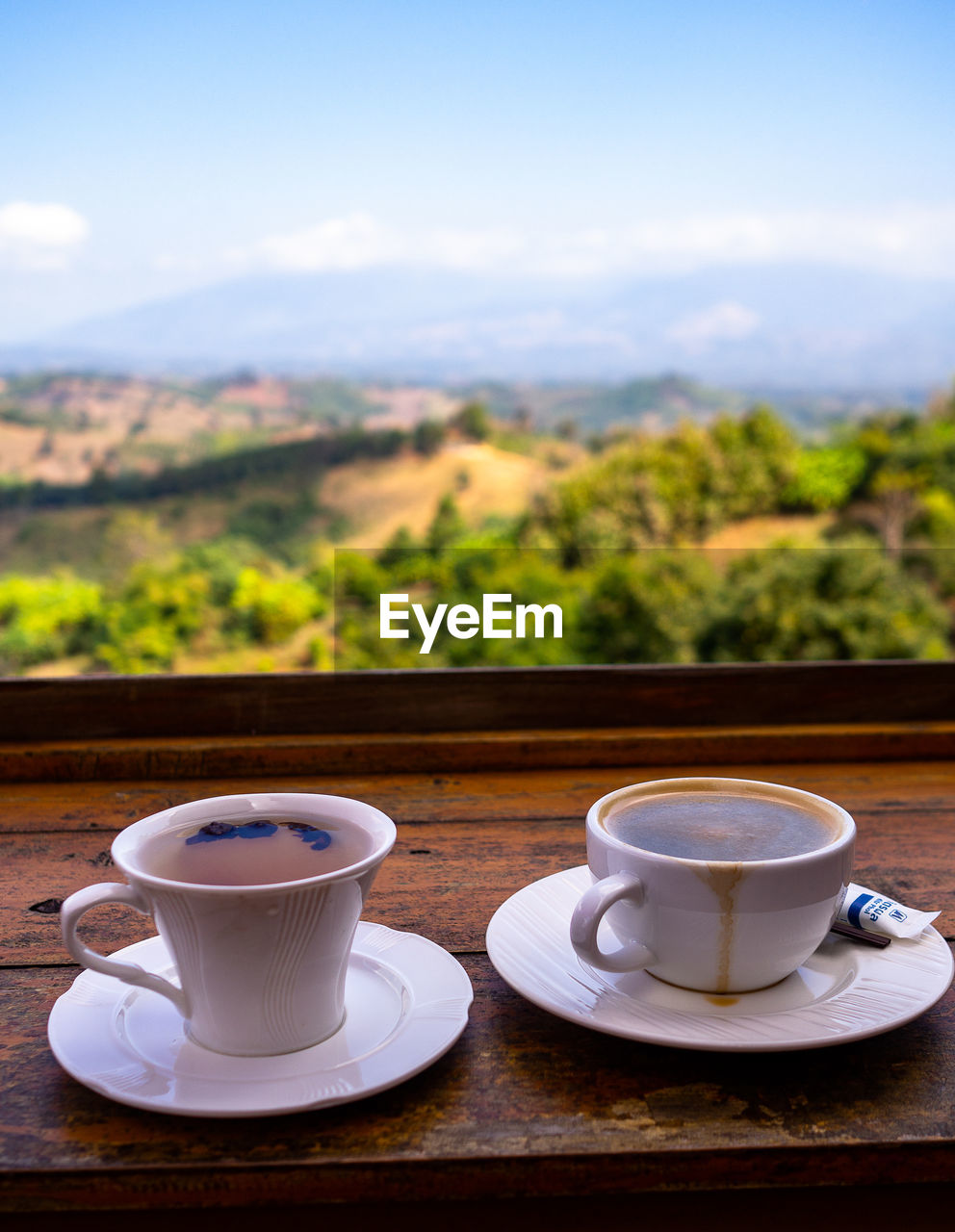 mug, cup, food and drink, drink, coffee, crockery, coffee cup, refreshment, saucer, hot drink, morning, no people, nature, table, tea, day, sky, food, outdoors, focus on foreground, tea cup, mountain, landscape, plant, wood, relaxation, spoon, freshness, heat, still life, tranquil scene, tableware