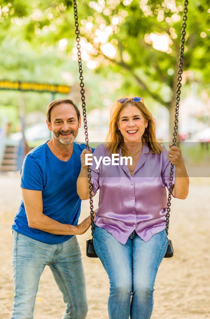 rear view of woman sitting on swing at park