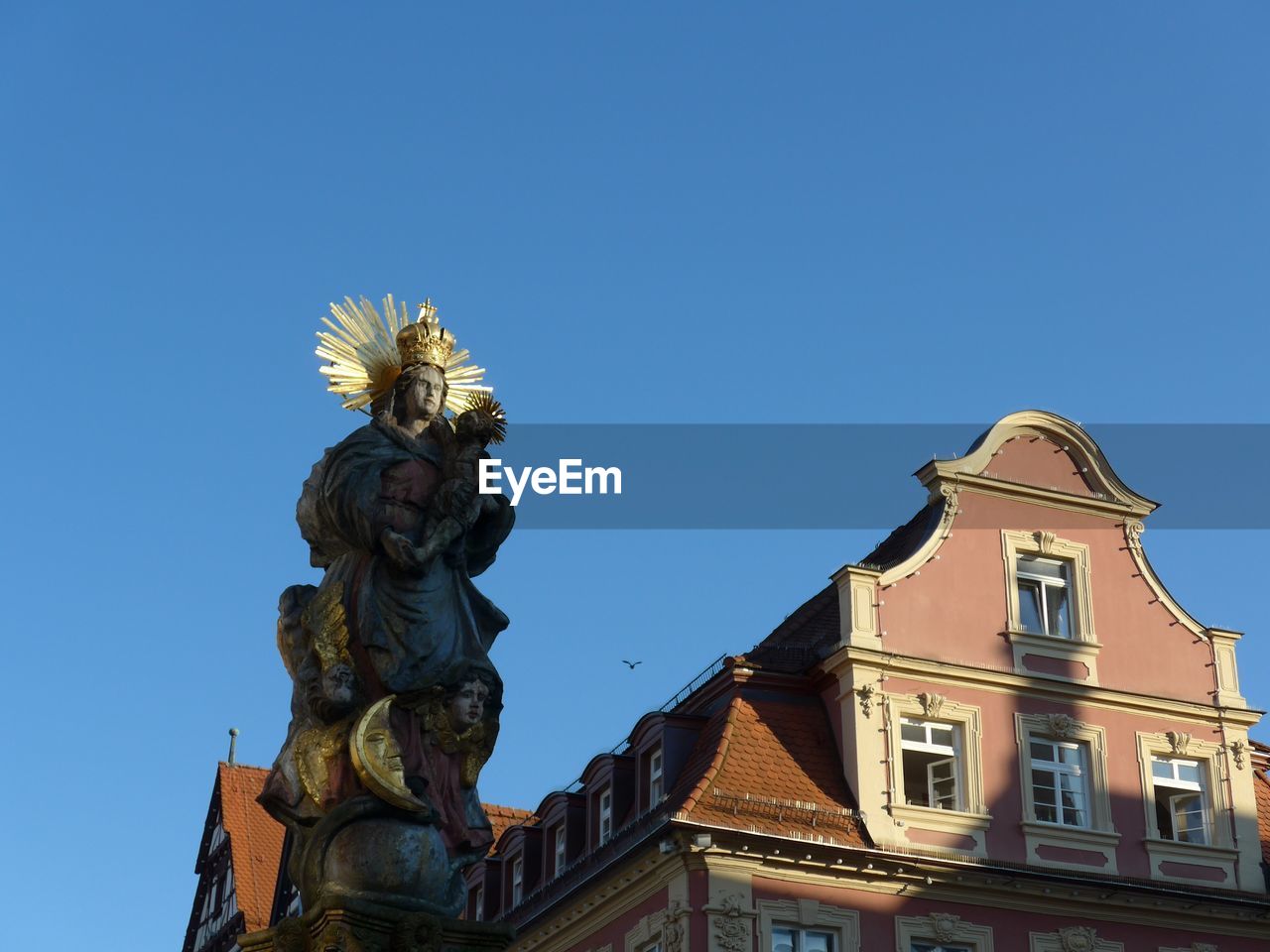 Low angle view of statue against sky in city