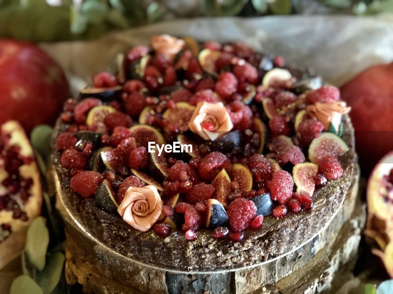 Close-up of chopped strawberries in plate ontop of wedding cake