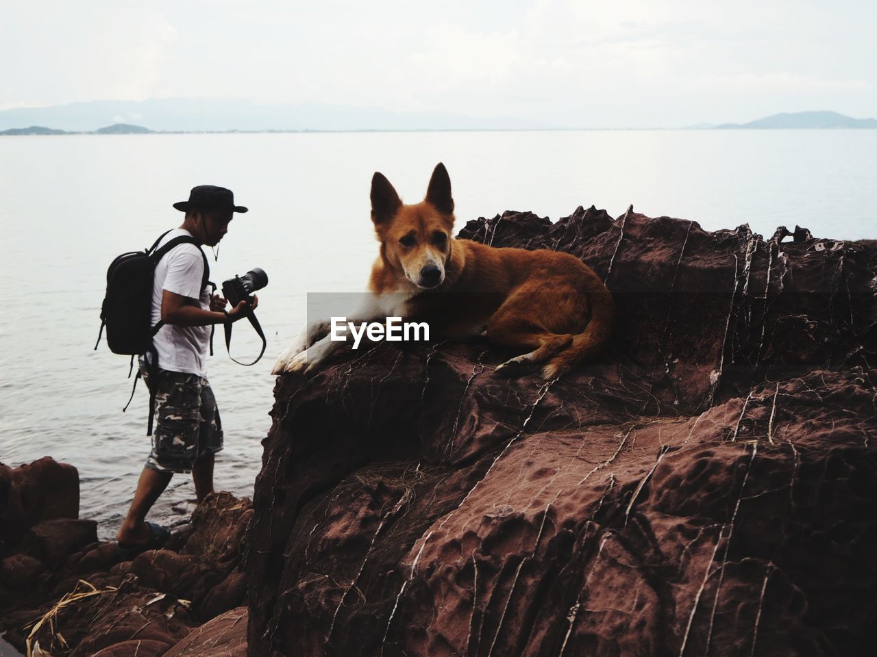 VIEW OF TWO PEOPLE ON ROCK