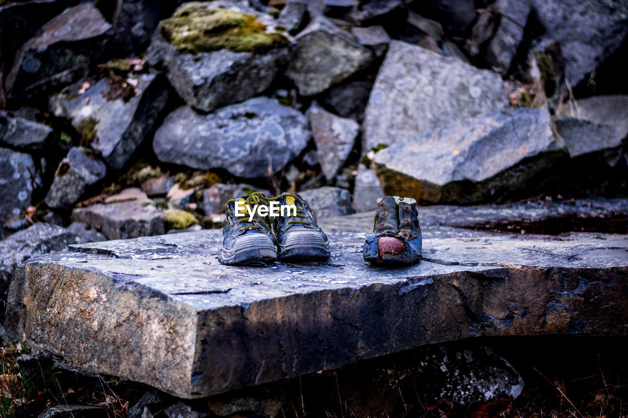 Abandoned shoes on rock