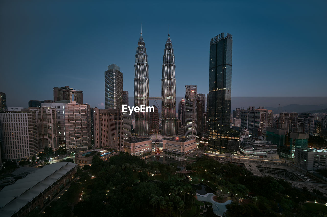 Panoramic view of buildings in city against sky