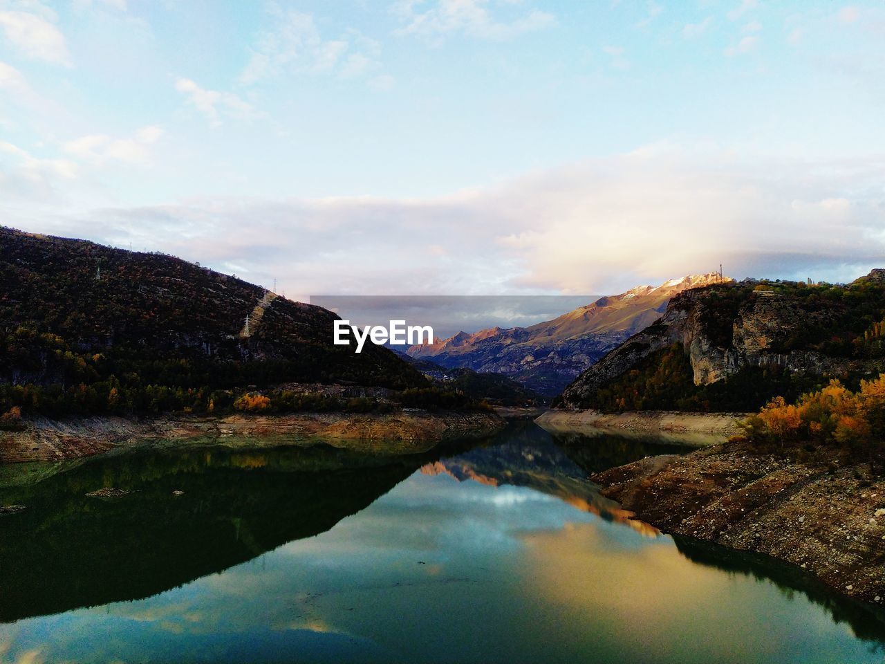 Scenic view of lake and mountains against sky